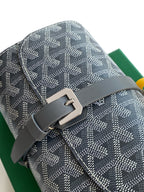 Goyard patterned bag detail with gray buckle hardware and monogram canvas