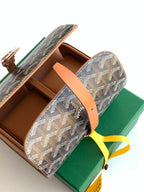 Goyard bag open view: tan leather pouches and dark monogram canvas flap