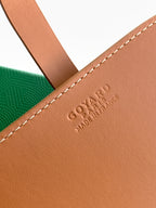 Tan leather Goyard bag detail with embossed logo and stitched edge