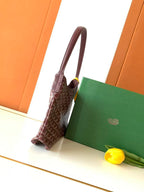 Monogram hobo bag with top handle, side view, brown canvas and leather trim