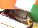 Open monogram bag interior with zipper top and brown leather lining