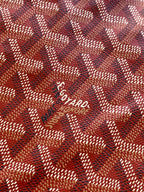 Red Goyard-pattern canvas fabric close-up with small Goyard logo print