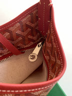 Goyard hobo bag interior close-up with zip pocket and gold-tone ring pull