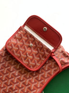 Goyard hobo bag flap pocket close-up with snap button and red leather trim