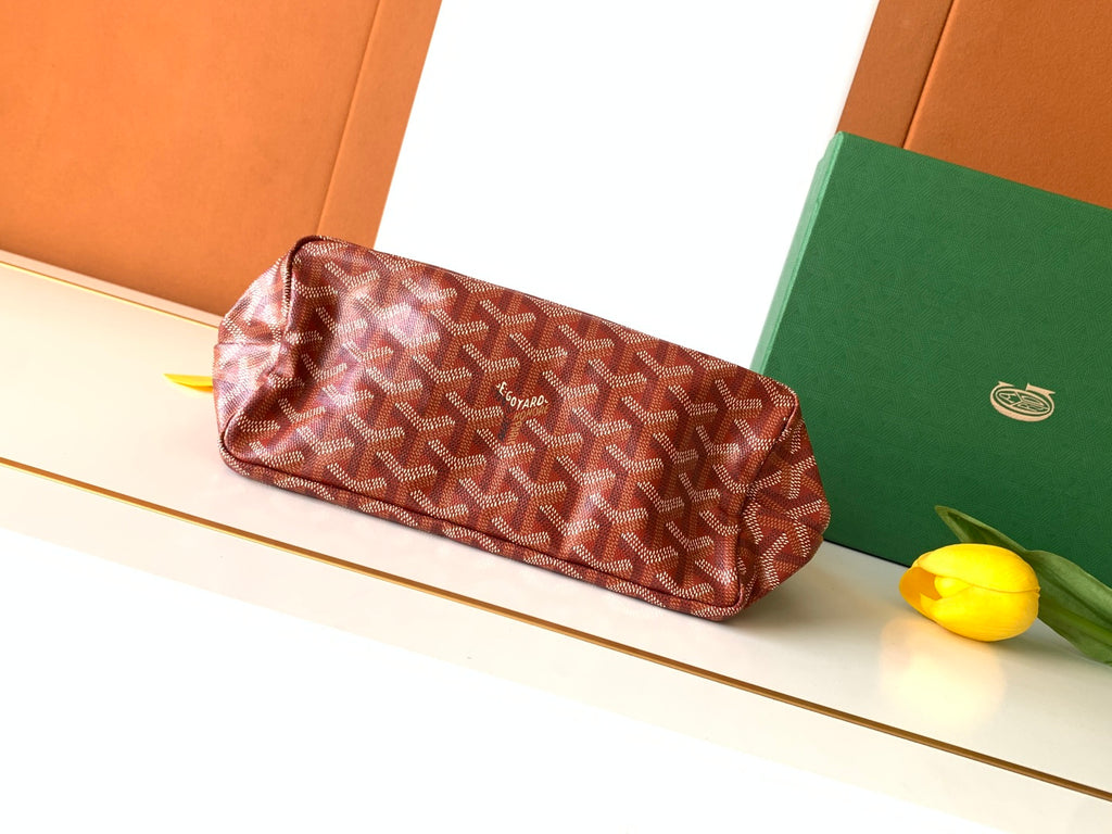 Goyard hobo bag with red patterned exterior and top handle, with green pouch lining