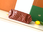 Goyard hobo bag with red patterned exterior and top handle, with green pouch lining