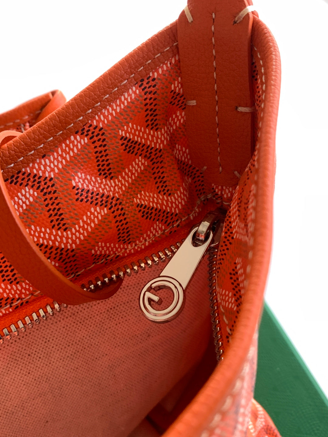 Goyard patterned handbag with zip closure and metal ring pull, orange leather lining