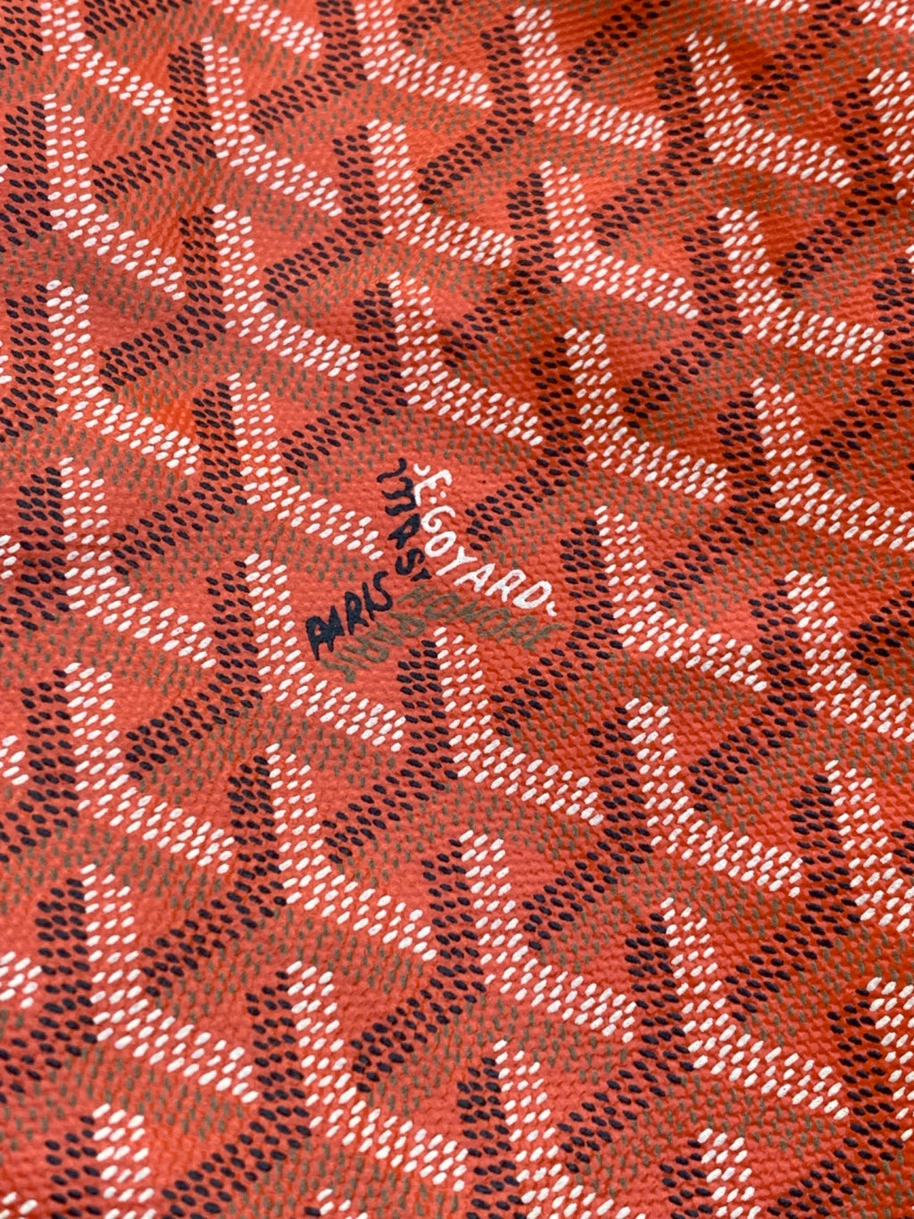 Goyard Paris Saint Honoré logo stamp on orange patterned fabric