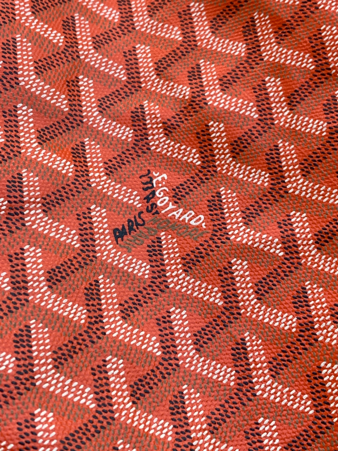 Goyard Paris Saint Honoré logo stamp on orange patterned fabric