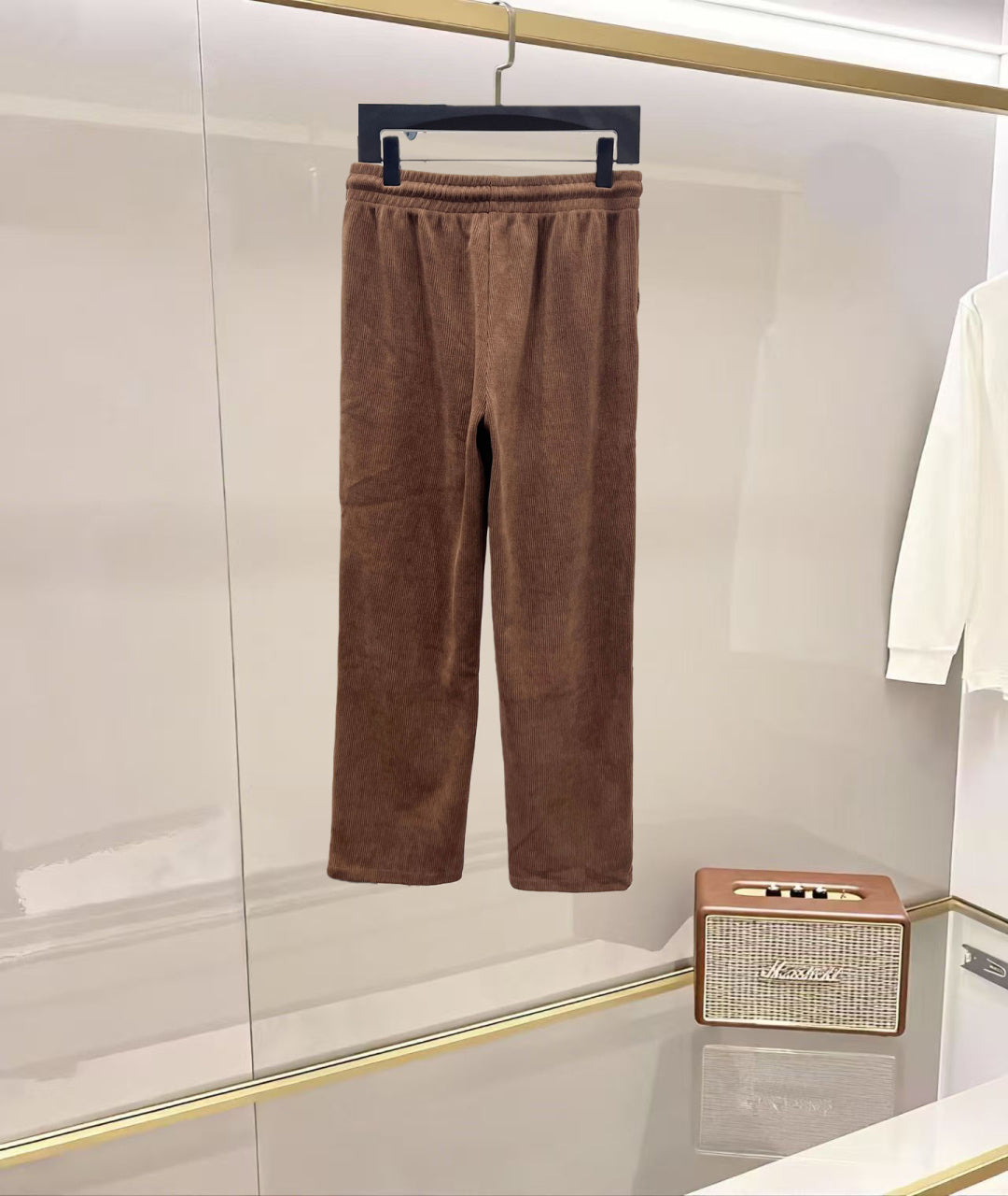 Brown corduroy pants with elastic waistband, drawstring, and relaxed straight legs