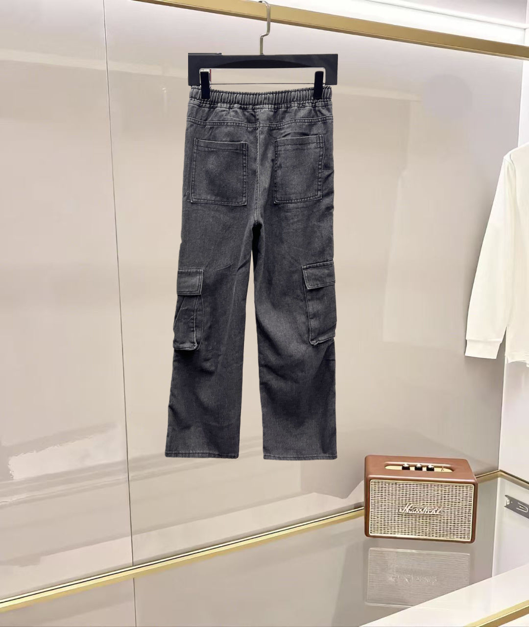 Dark gray denim cargo pants with elastic waist and cargo flap pockets