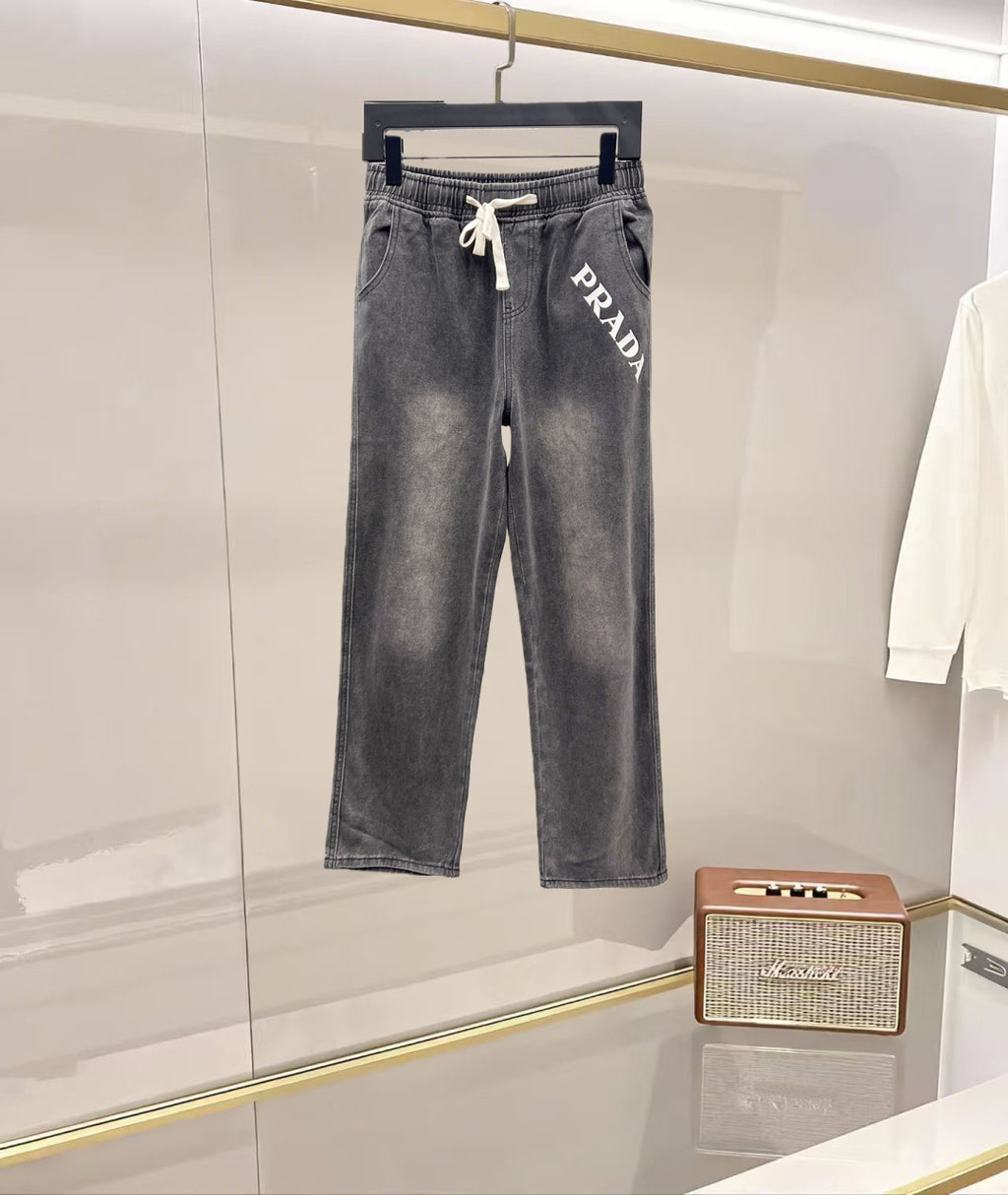 Denim pants in dark gray with white PRADA graphic and drawstring waist