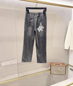 Dark gray denim pants with elastic waistband and white graphic logo on leg