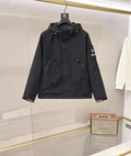 Black hooded coat with button front, flap pockets, and Prada logo patch
