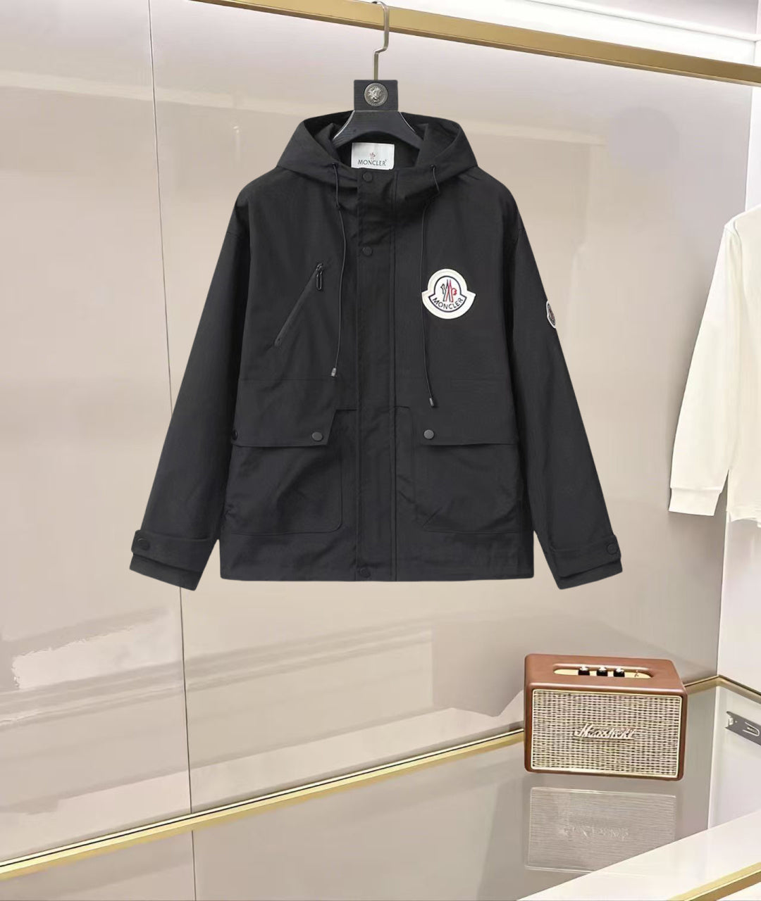 Long hooded Moncler jacket in dark navy with front zipper and logo patch