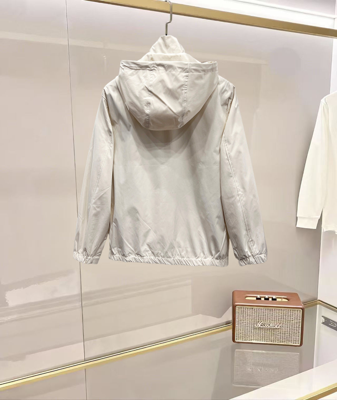 White hooded jacket with full back view and front zipper, elastic cuffs and hem