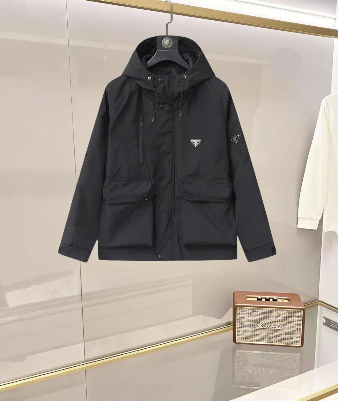 Black hooded long jacket with front buttons and Prada triangle logo patch