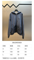 Balenciaga light blue zip hoodie with hood and front pockets on a hanger