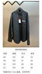 Balenciaga long-sleeve button-up shirt on hanger, dark fabric and chest label