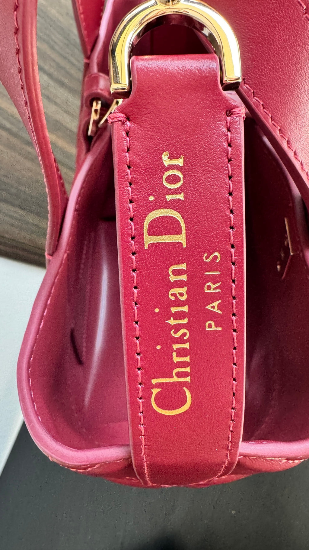 Pink Dior tote bag with gold top handle hardware and interior logo patch