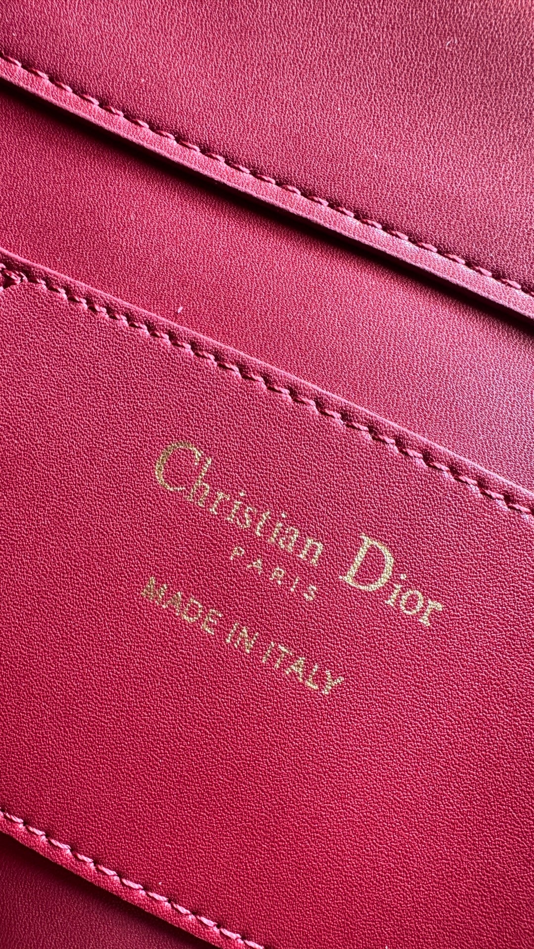 Pink Dior bag leather logo patch with decorative stitching and text detailing