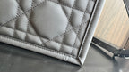 Quilted lower panel of Dior bag with stitched trim and smooth leather edge