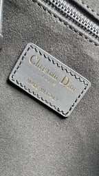 Christian Dior label on dark fabric: Made in Italy, stitched onto bag lining