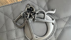Dior bag strap clasp and ring hardware on quilted dark gray leather