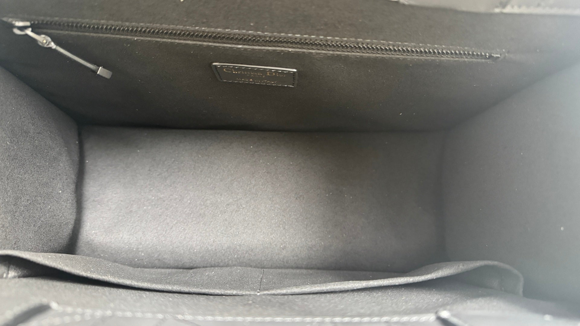 Dior tote bag interior with fabric lining and stitched top edge