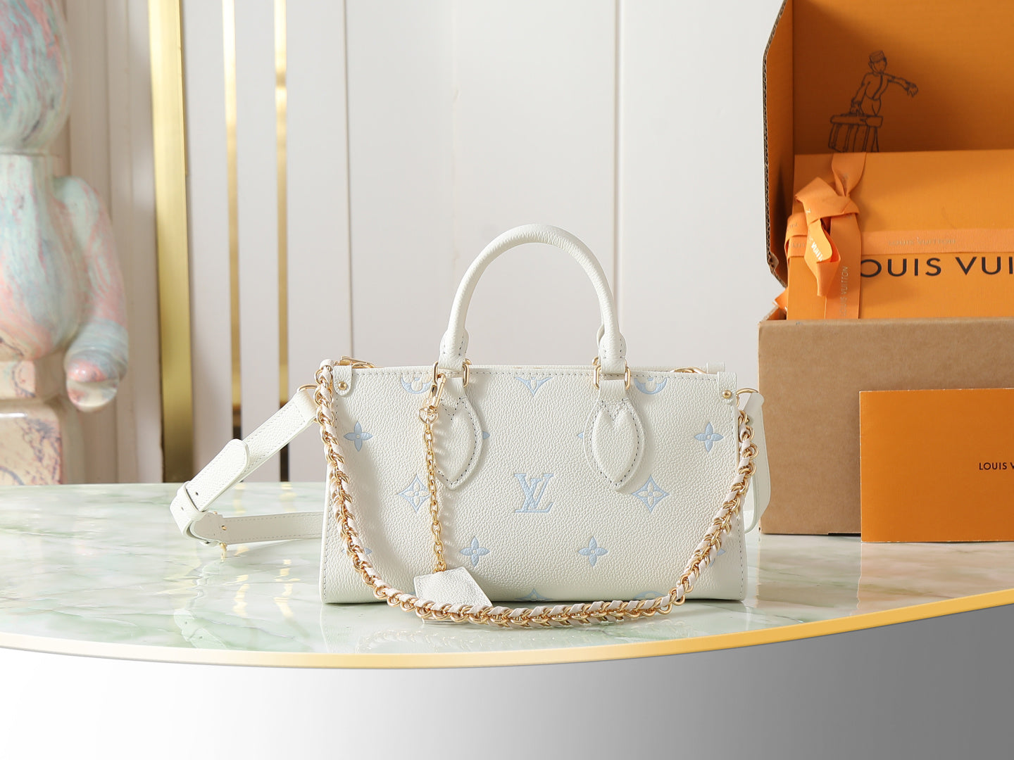 Louis Vuitton mini handbag in white pebbled leather with light blue monogram, top handles