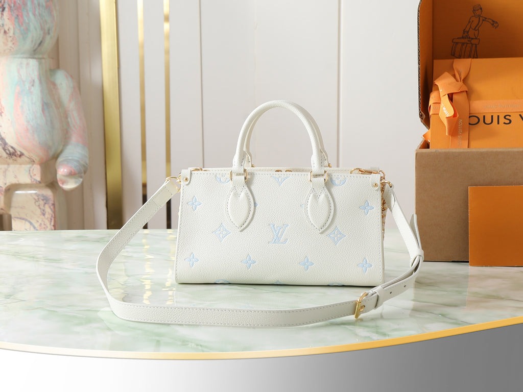 Louis Vuitton mini handbag front view in white pebbled leather with light blue motifs, strap