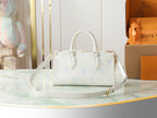 Louis Vuitton mini handbag front view in white pebbled leather with light blue motifs, strap