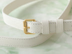 Louis Vuitton adjustable strap end with gold buckle on white pebbled leather