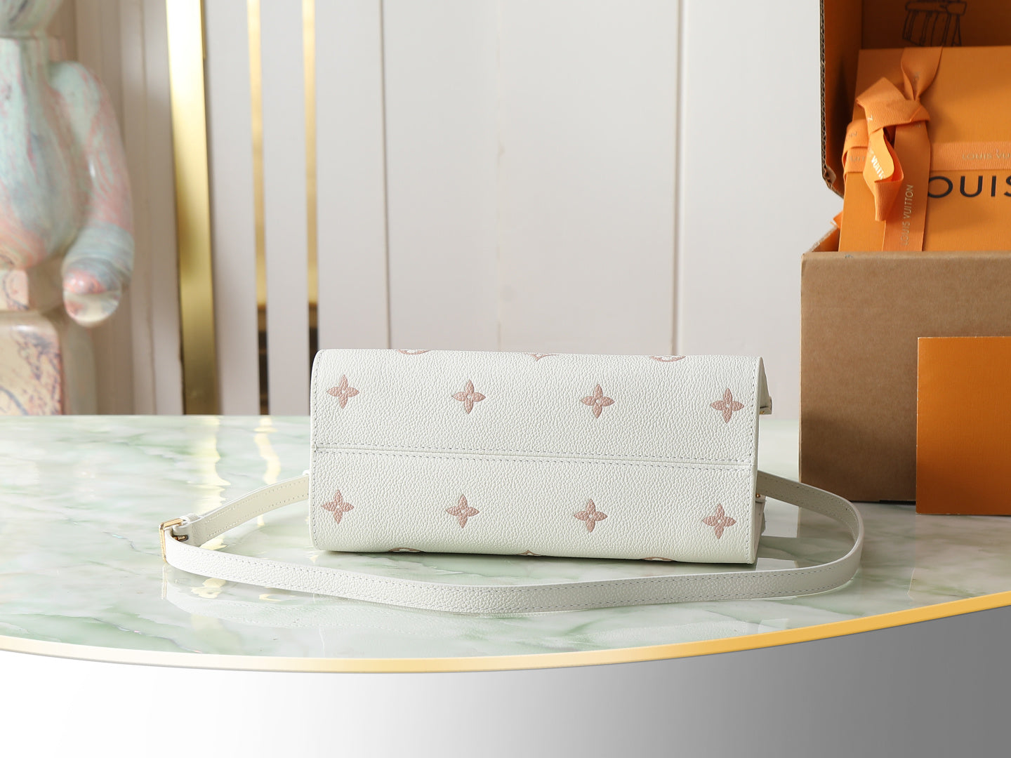 Louis Vuitton bag in white with monogram pattern, top closure and shoulder strap
