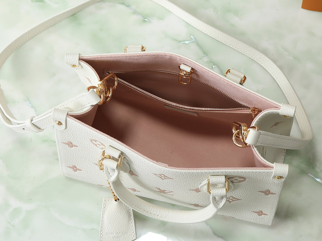Louis Vuitton bag interior view with pink lining, zip pocket, and monogram exterior