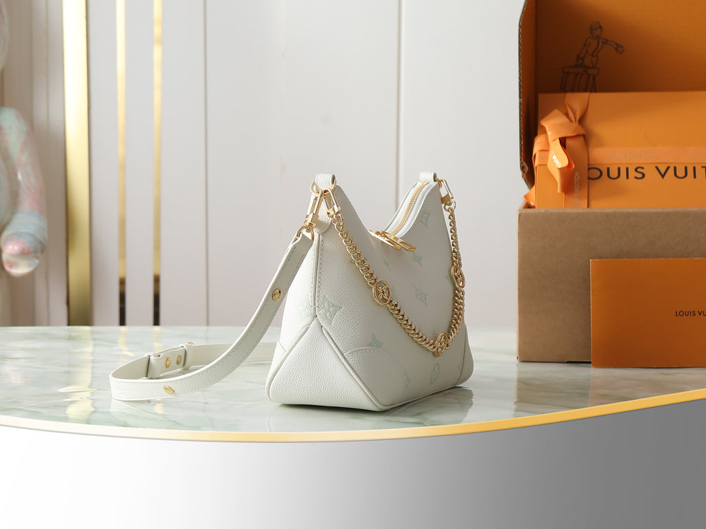 White hobo bag with gold chain crossbody strap and top handles