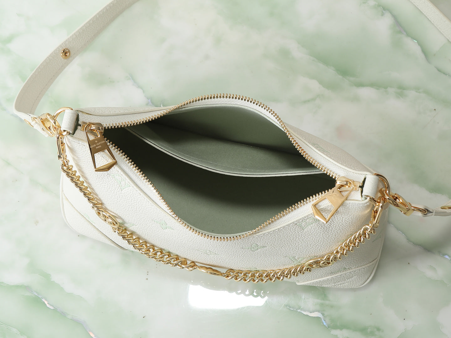 White hobo bag interior with gold-tone zipper and hanging chain