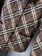 Burberry quilted plaid jacket close-up with metal buttons and drawstring hem