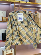 Burberry plaid jacket, cream with green and navy check, angled view of front zipper