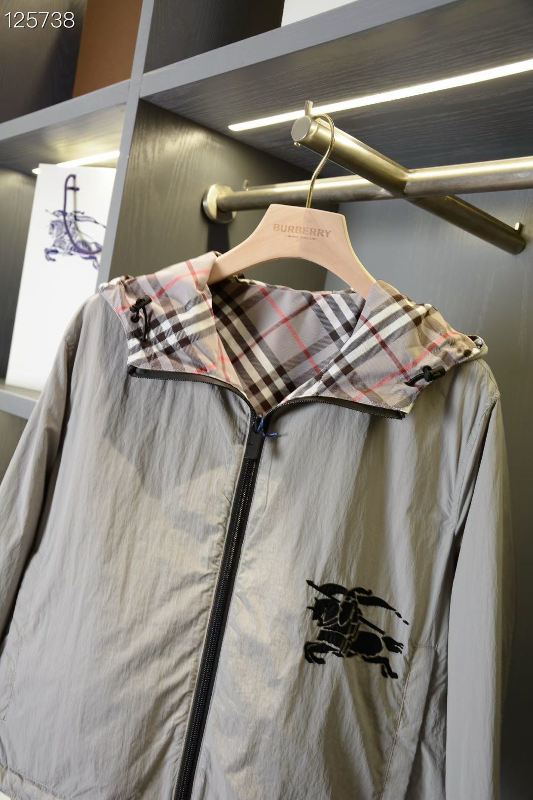 Plaid hooded jacket with front zipper and horse logo patch on the chest