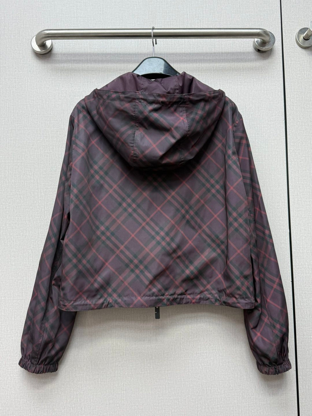 Burberry hooded plaid jacket back view with draped hood and elastic cuffs.