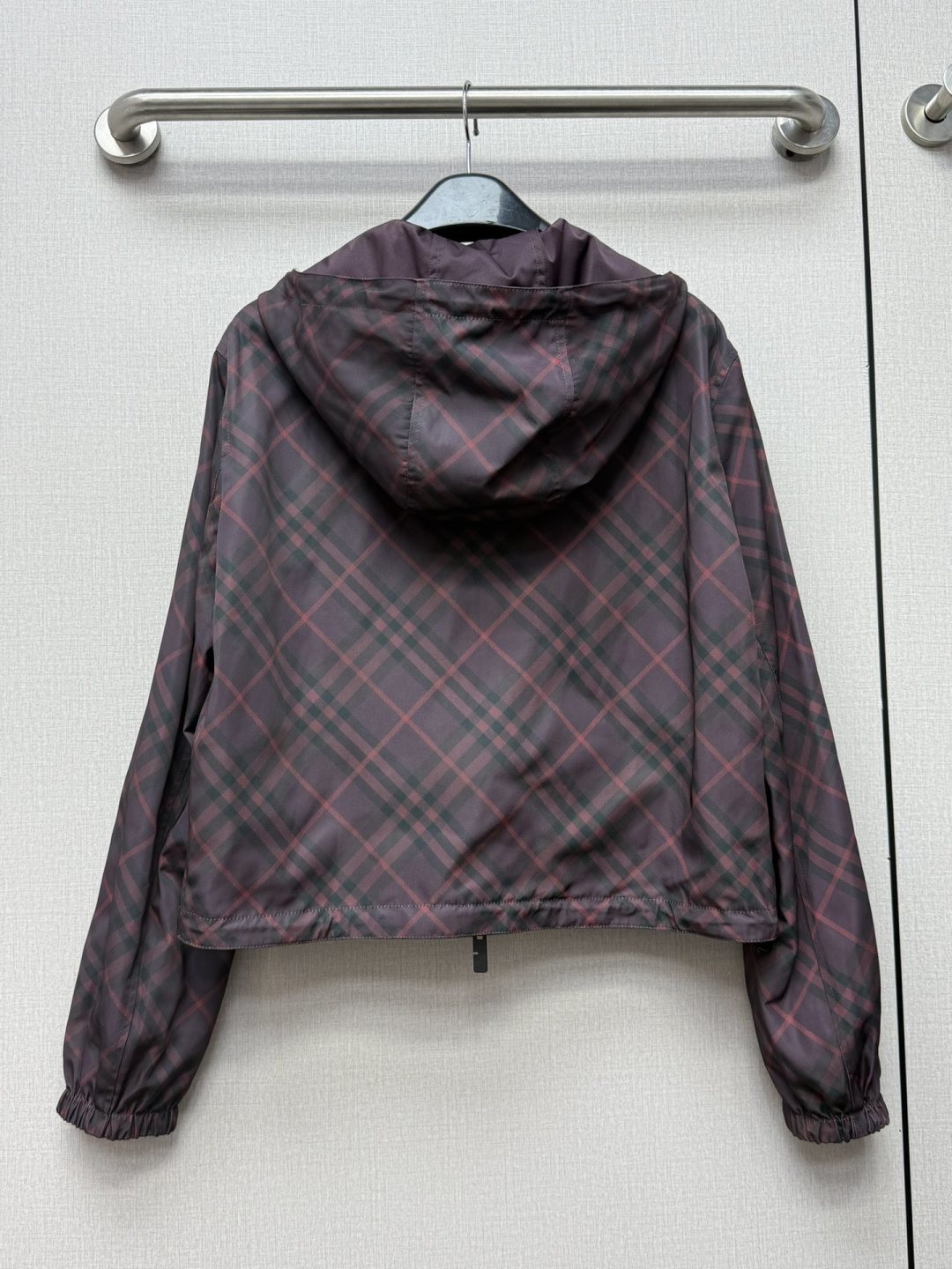 Burberry hooded plaid jacket back view with draped hood and elastic cuffs.