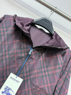 Burberry plaid hooded jacket with zip front and interior lining detail at chest.