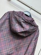 Burberry plaid hooded jacket with folded hood and zip front in dark purple.