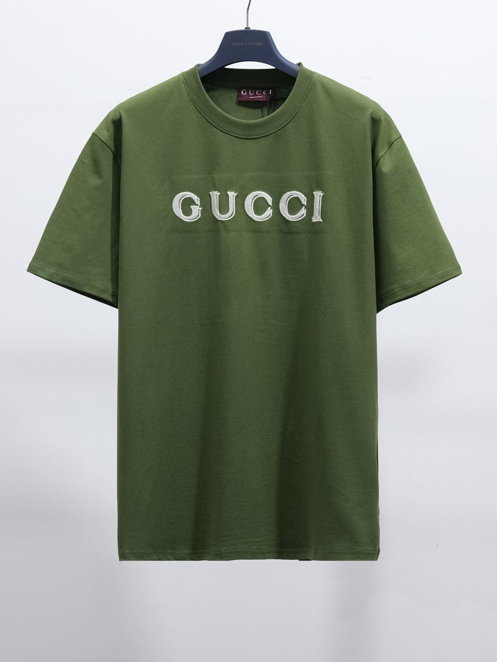 Olive green crew-neck T-shirt with white Gucci logo on chest