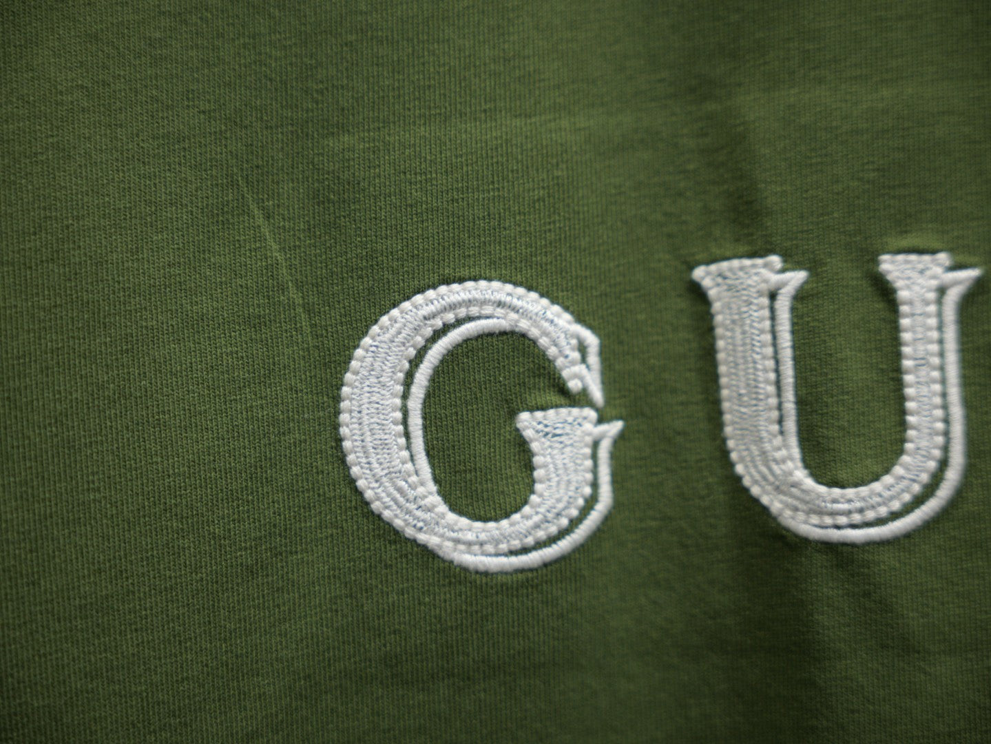 Olive green T-shirt with white Gucci embroidery detail