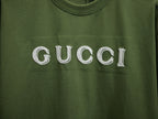 Olive green T-shirt with large white Gucci lettering