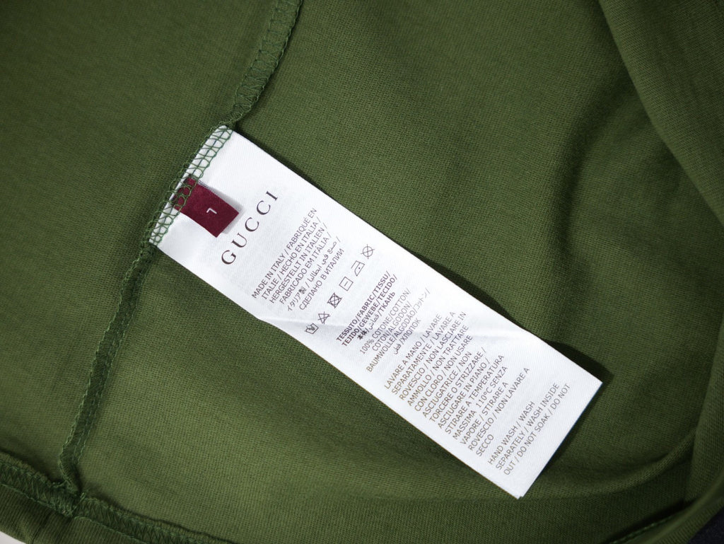 Olive green T-shirt interior with size and care label