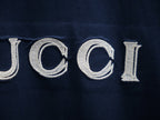 Embroidered GUCCI lettering on a dark navy short-sleeve T-shirt