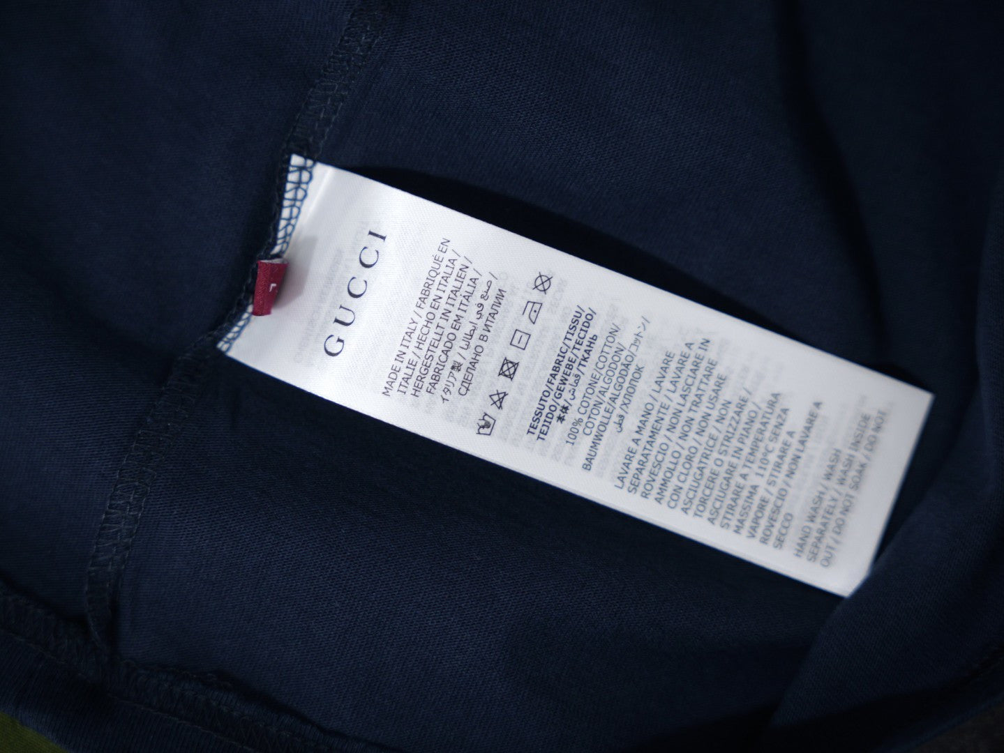 Interior care label on a dark navy short-sleeve T-shirt